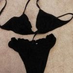 Női XS-es S-es fekete pamutcsipke anyagú bikini, fürdőruha fotó