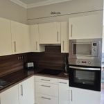 Kopmlett konyhabútor beépített gépekkel fotó